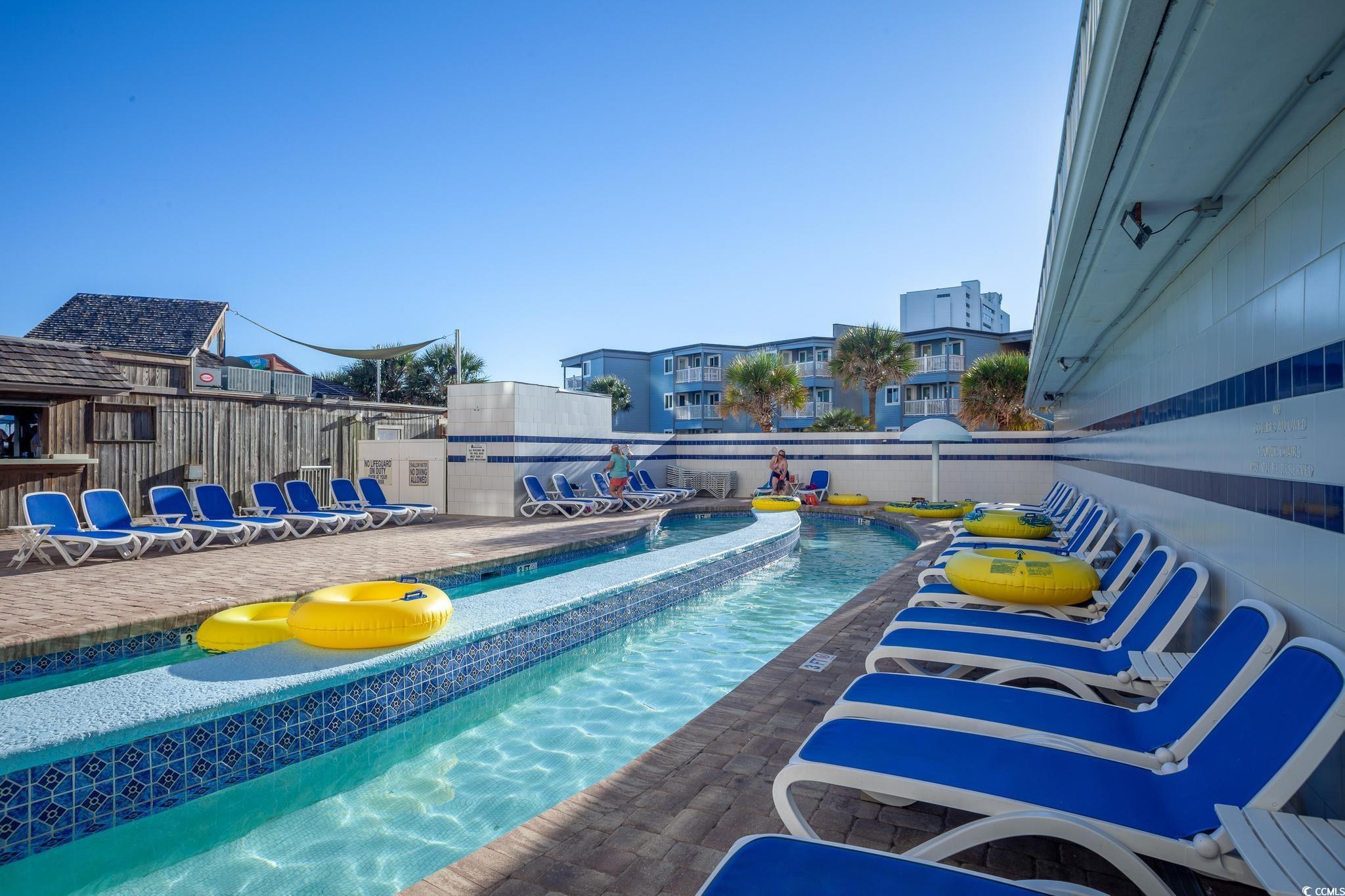 9550 Shore Drive, Unit 1728 Myrtle Beach, SC 29572 - Photo 28 of 36 Community pool featuring a patio area
