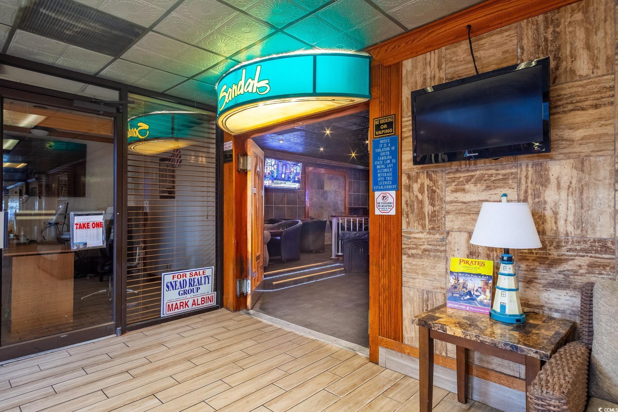 9550 Shore Drive, Unit 1728 Myrtle Beach, SC 29572 - Photo 33 of 36 Corridor with a wainscoted wall, wood finish floors, and a paneled ceiling
