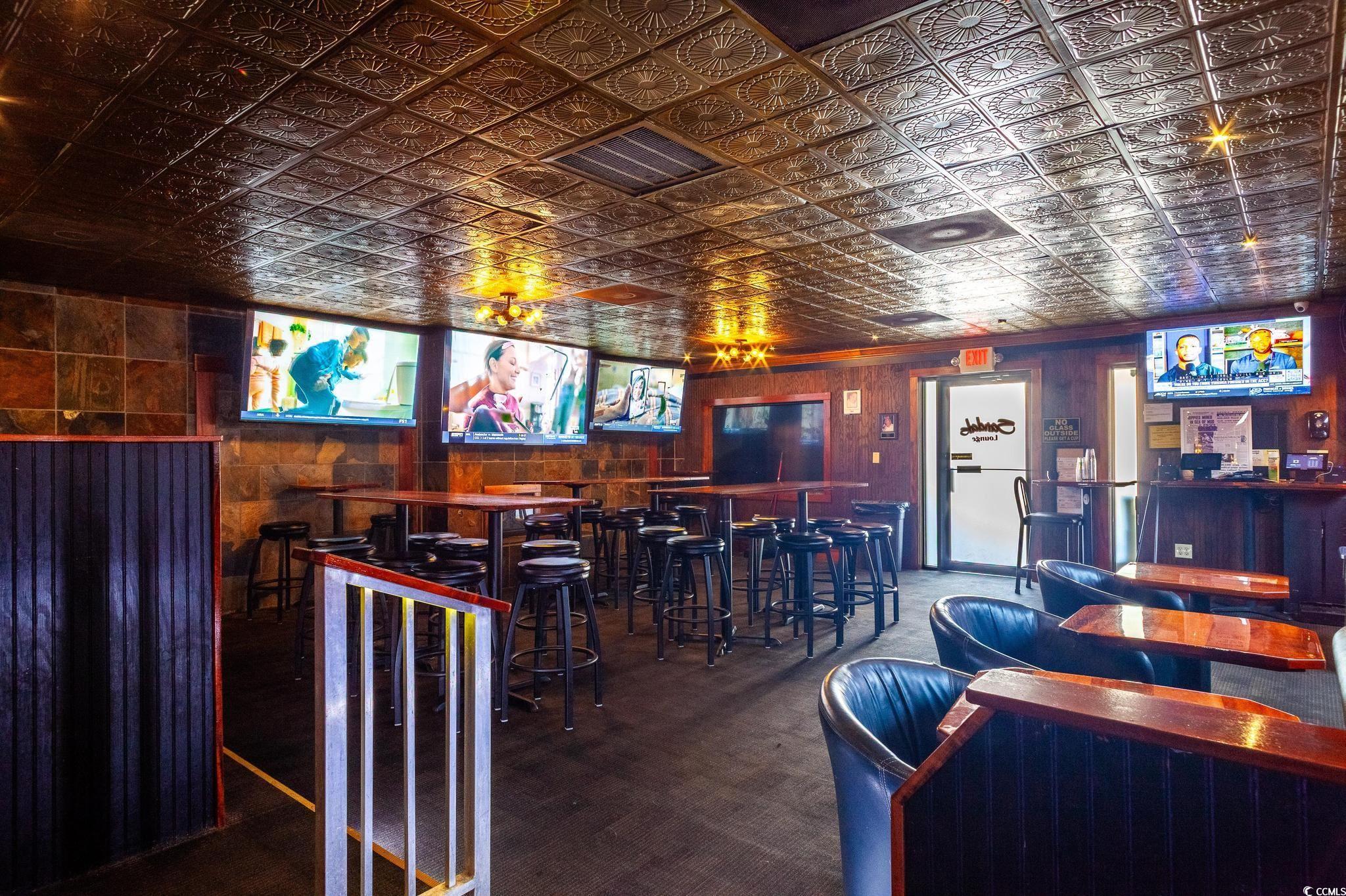 9550 Shore Drive, Unit 1728 Myrtle Beach, SC 29572 - Photo 35 of 36 Cinema room featuring an ornate ceiling, carpet flooring, and a community bar