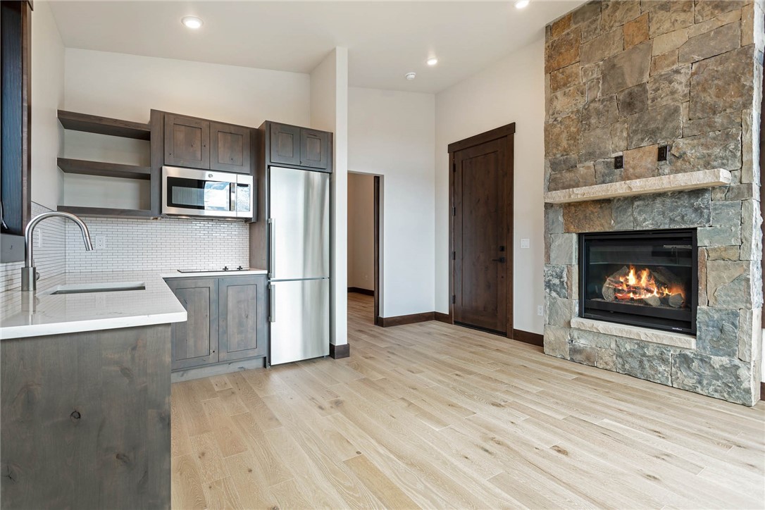 280 McKay Road Silverthorne, CO 80498 - Photo 9 of 24 a living room with stainless steel appliances wooden floor and a fireplace