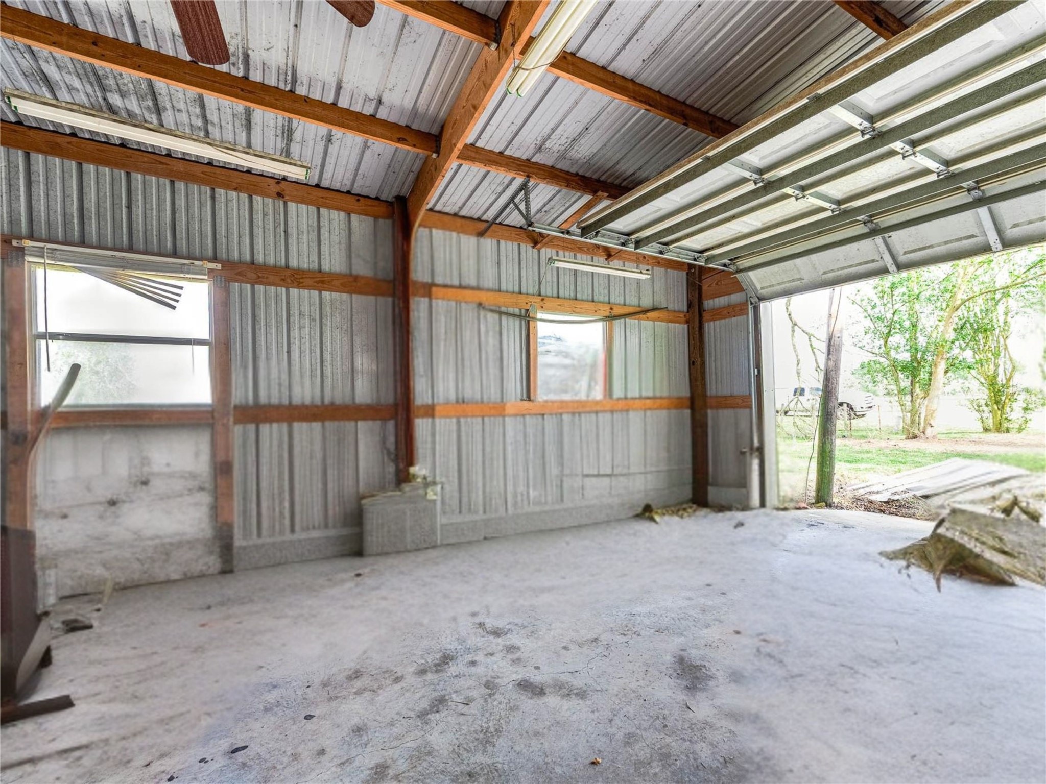1619 County Road 387 Rosharon, TX 77583 - Photo 6 of 49 Metal workshop interior with two windows and manual large door offering great natural light.
