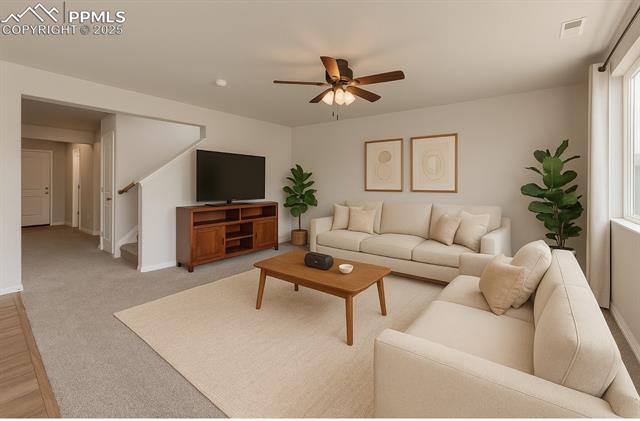 11053 Avena Road Peyton, CO 80831 - Photo 5 of 27 Living area with a ceiling fan and stairway