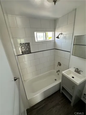 a bathroom with a bathtub a sink a toilet and a shower