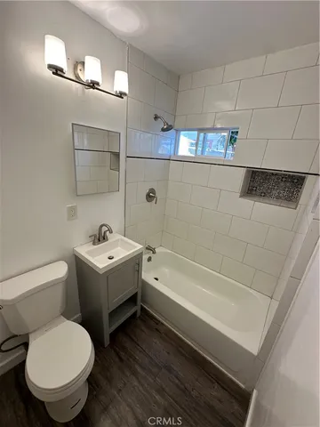a bathroom with a toilet a sink and bathtub
