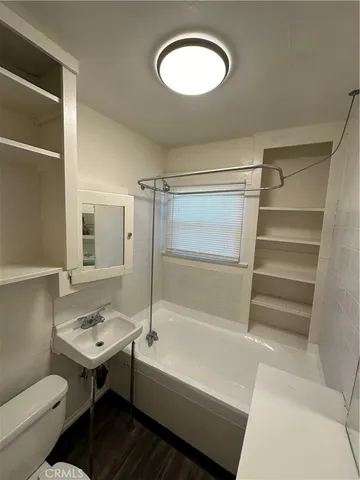 a bathroom with a sink mirror vanity and toilet