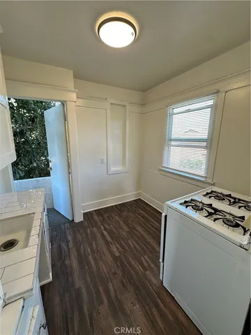 a kitchen with granite countertop a stove and a refrigerator