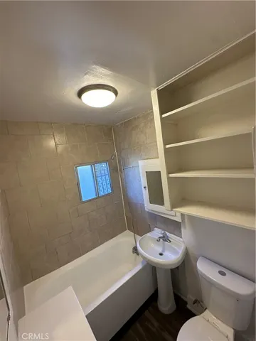 a bathroom with a sink a toilet and a bathtub