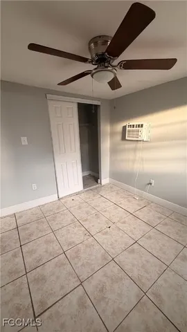 a bedroom with a bed and a ceiling fan