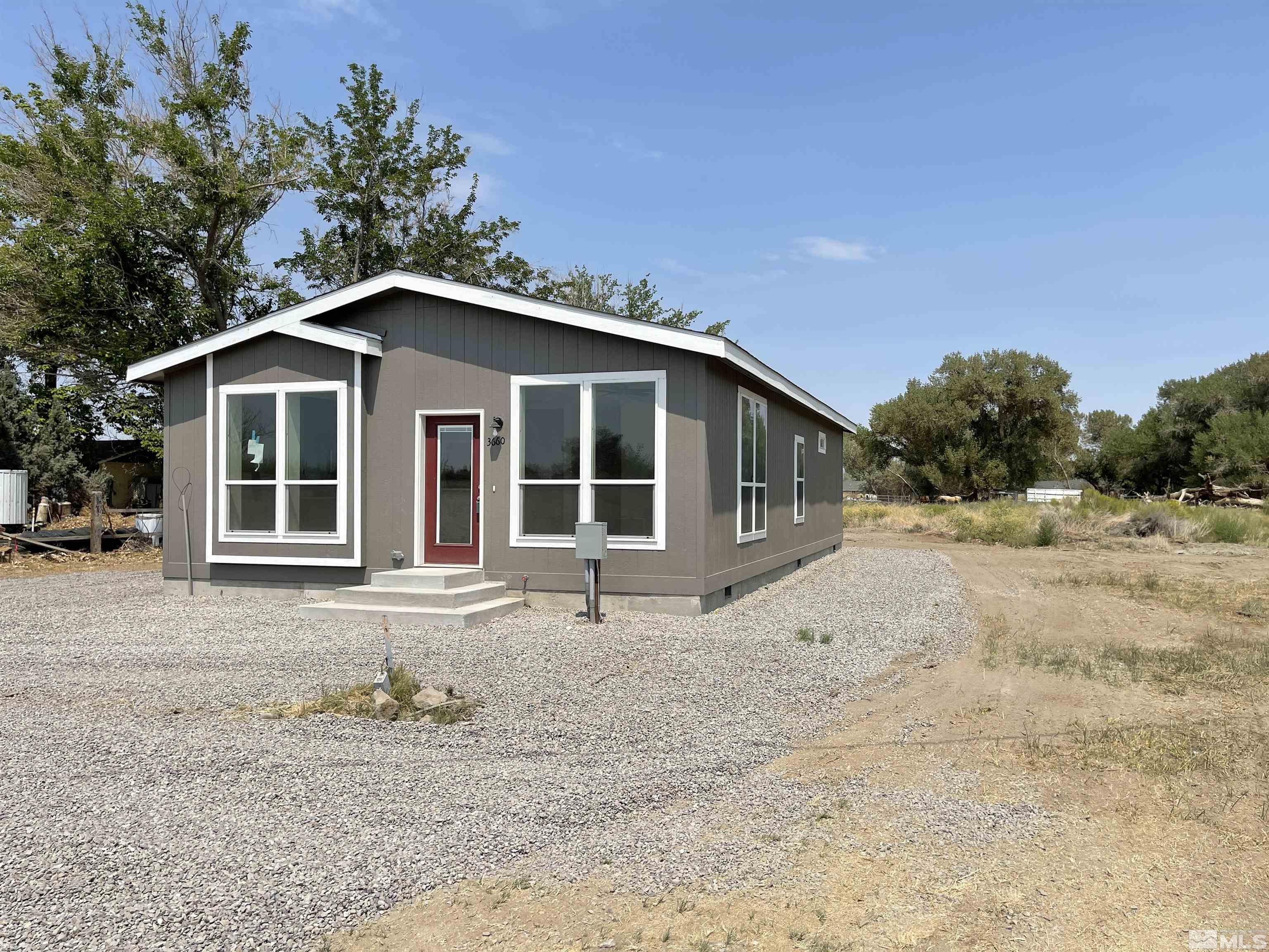 3660 Bottom Road Fallon, NV 89406 - Photo 2 of 13 a front view of a house with a yard and garage