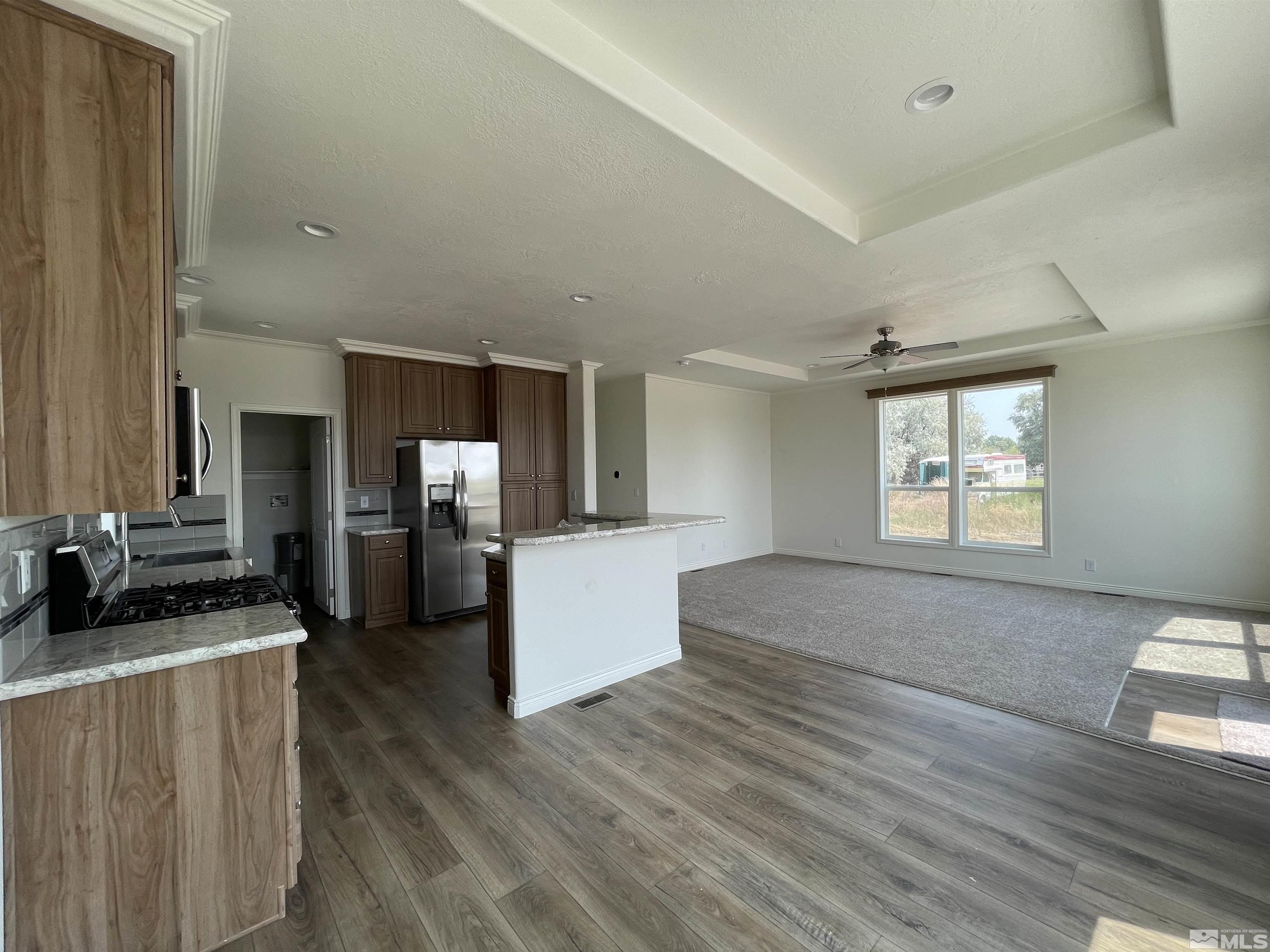 3660 Bottom Road Fallon, NV 89406 - Photo 4 of 13 a large living room with kitchen island wooden floor and stainless steel appliances