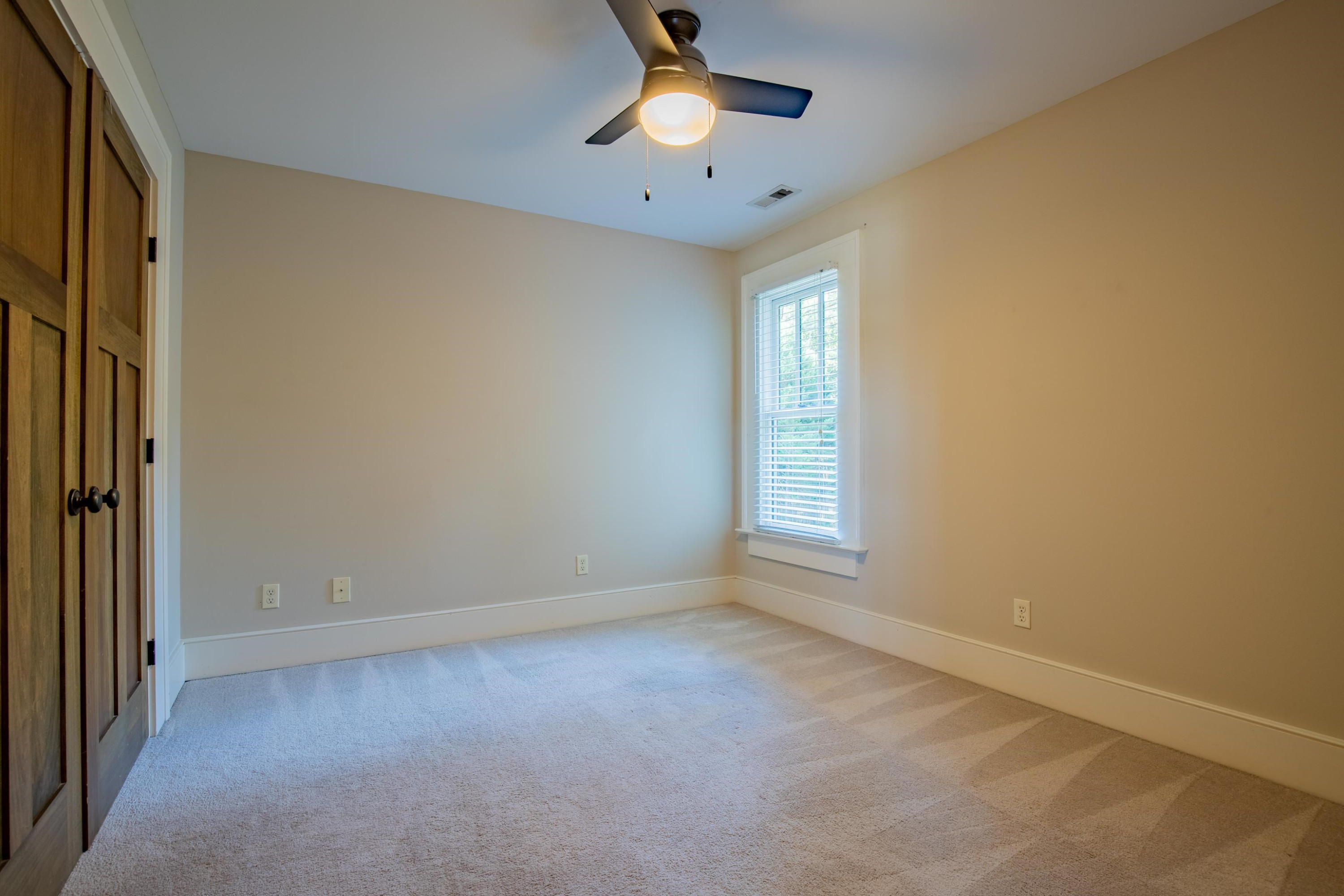 616 Mills Street Raleigh, NC 27608 - Photo 19 of 30 an empty room with closet and a chandelier fan