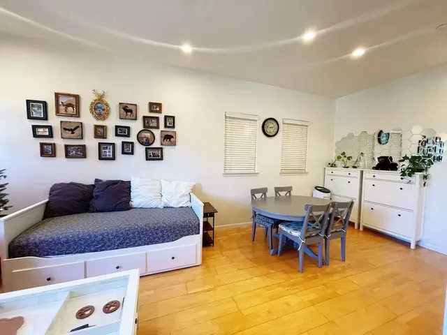 a living room with furniture and wooden floor