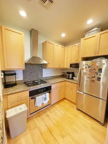 a kitchen with granite countertop a sink stainless steel appliances and counter space