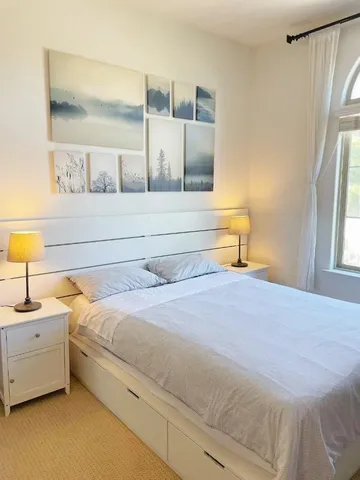 a bedroom with a bed and window