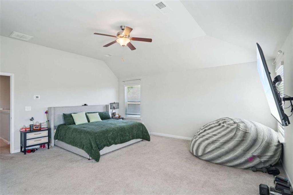 3605 Broadwick Lane Lithonia, GA 30038 - Photo 12 of 41 a bedroom with a bed and a chandelier