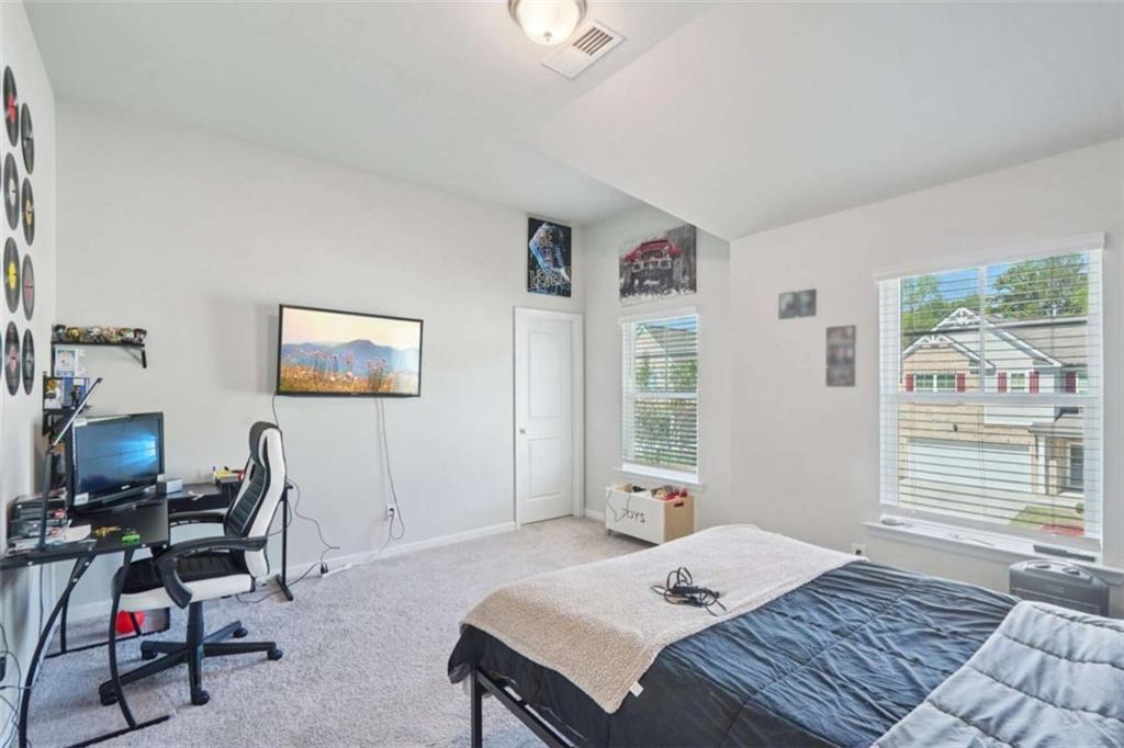 3605 Broadwick Lane Lithonia, GA 30038 - Photo 16 of 41 a bedroom that has a bed and a chair in it