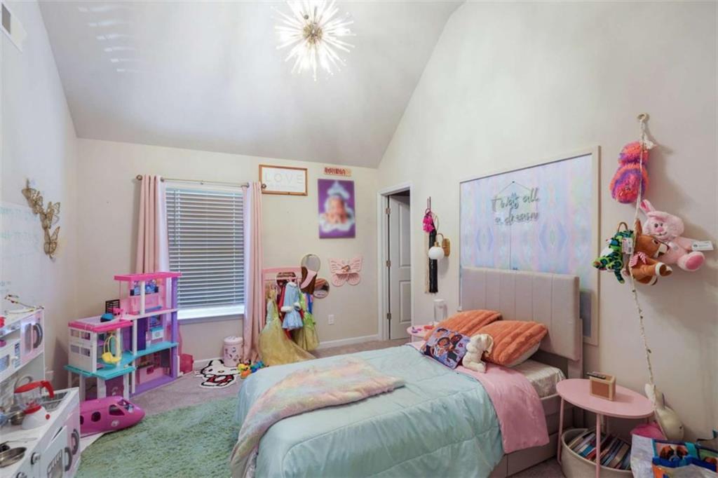 3605 Broadwick Lane Lithonia, GA 30038 - Photo 17 of 41 a bedroom with a bed and a chandelier