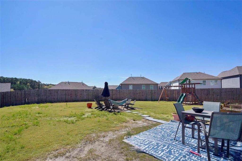 3605 Broadwick Lane Lithonia, GA 30038 - Photo 24 of 41 a view of a backyard with sitting area and a garden