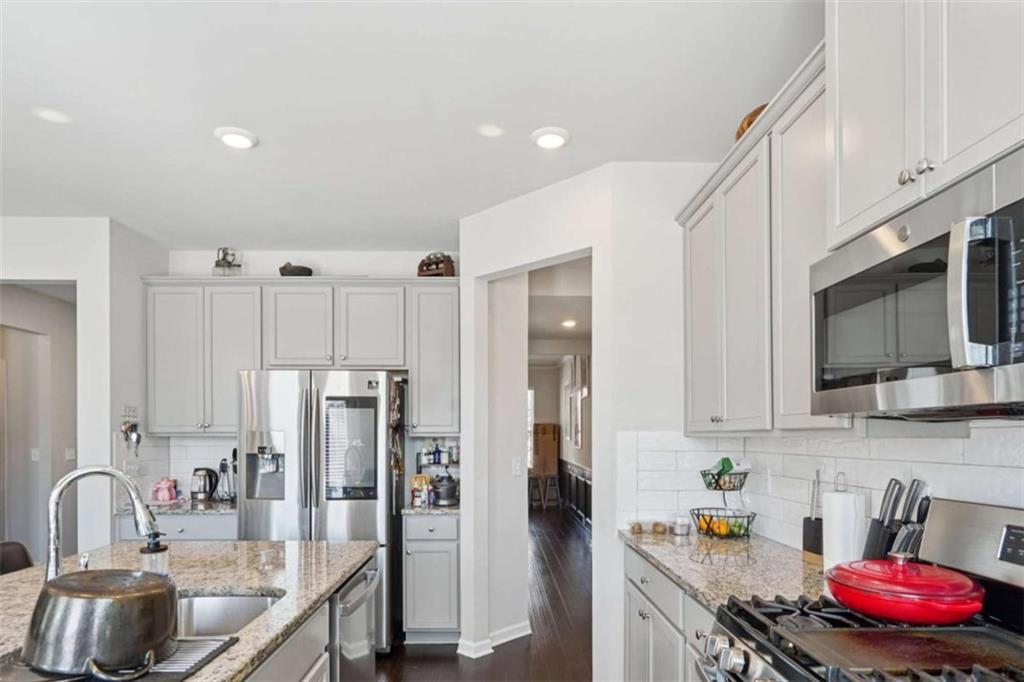 3605 Broadwick Lane Lithonia, GA 30038 - Photo 10 of 41 a kitchen with stainless steel appliances granite countertop a sink refrigerator and microwave