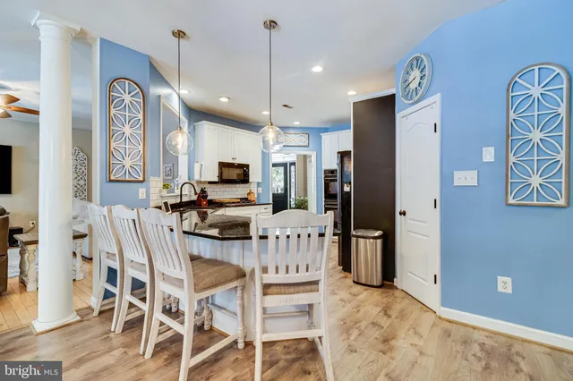 a bedroom with a bed and a mirror on the dresser