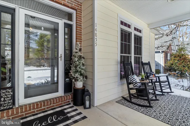a view of a hallway with wooden floor and a potted plant