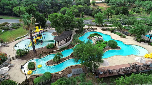 an aerial view of swimming pool patio and outdoor seating