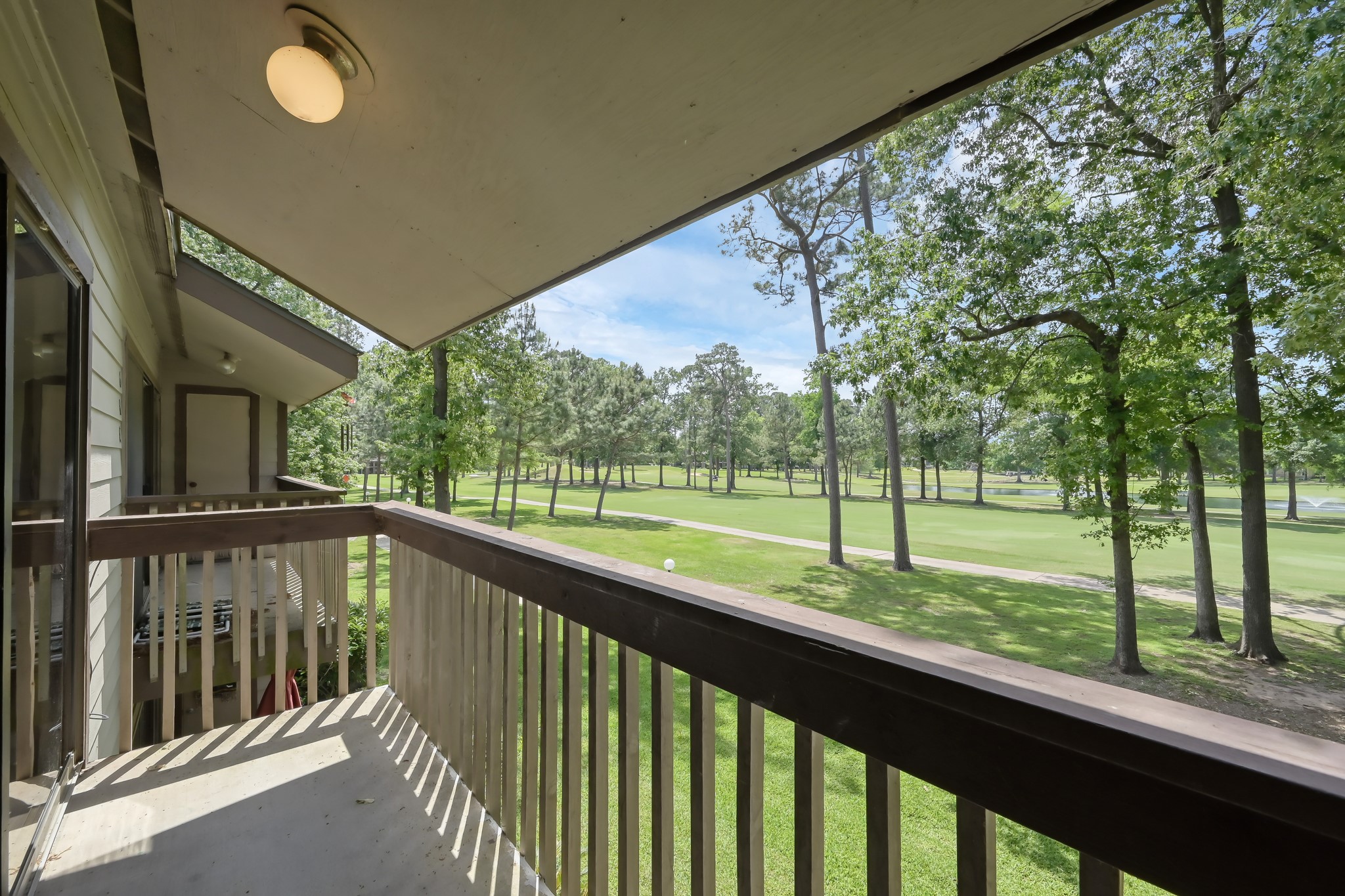 a view of a deck with a big yard