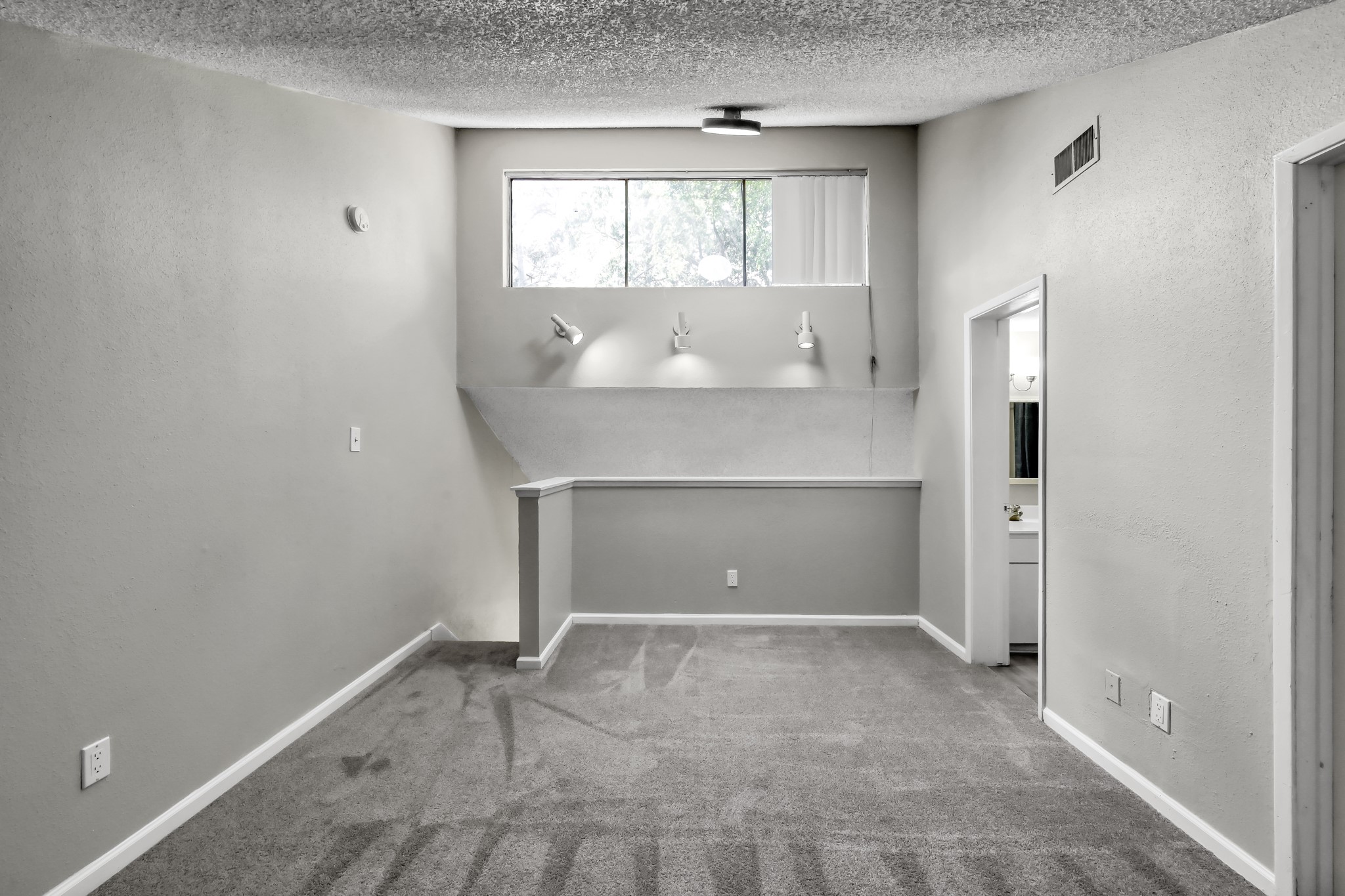 12900 Walden Road, Unit 604F Montgomery, TX 77356 - Photo 13 of 19 wooden floor in an empty room with a window