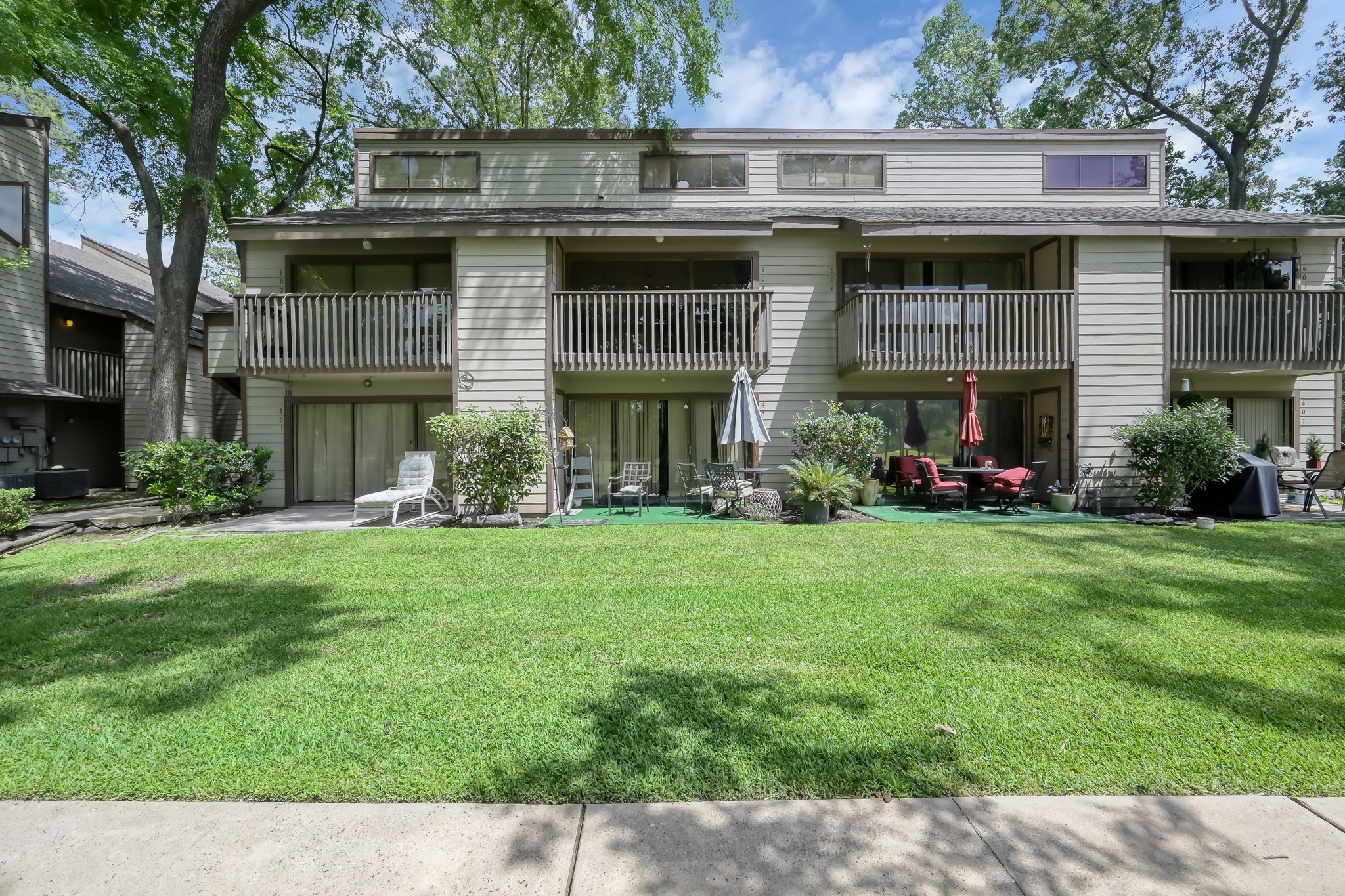 12900 Walden Road, Unit 604F Montgomery, TX 77356 - Photo 2 of 19 a front view of a house with a garden and plants