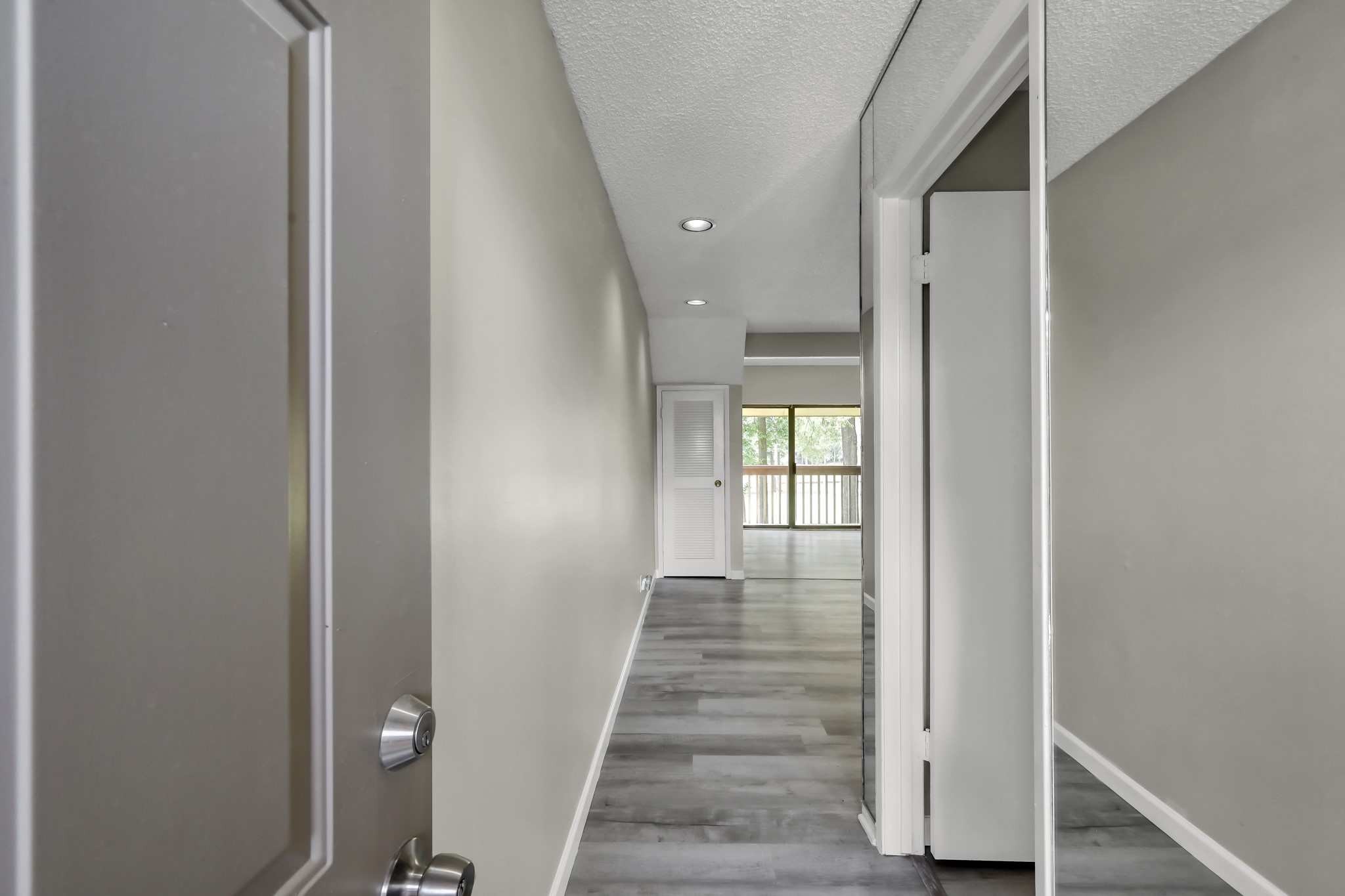 12900 Walden Road, Unit 604F Montgomery, TX 77356 - Photo 4 of 19 a view of a hallway with wooden floor and entryway