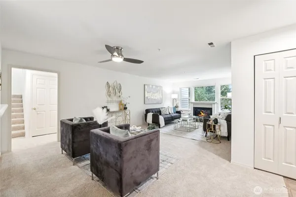 a living room with furniture a flat screen tv and a fireplace