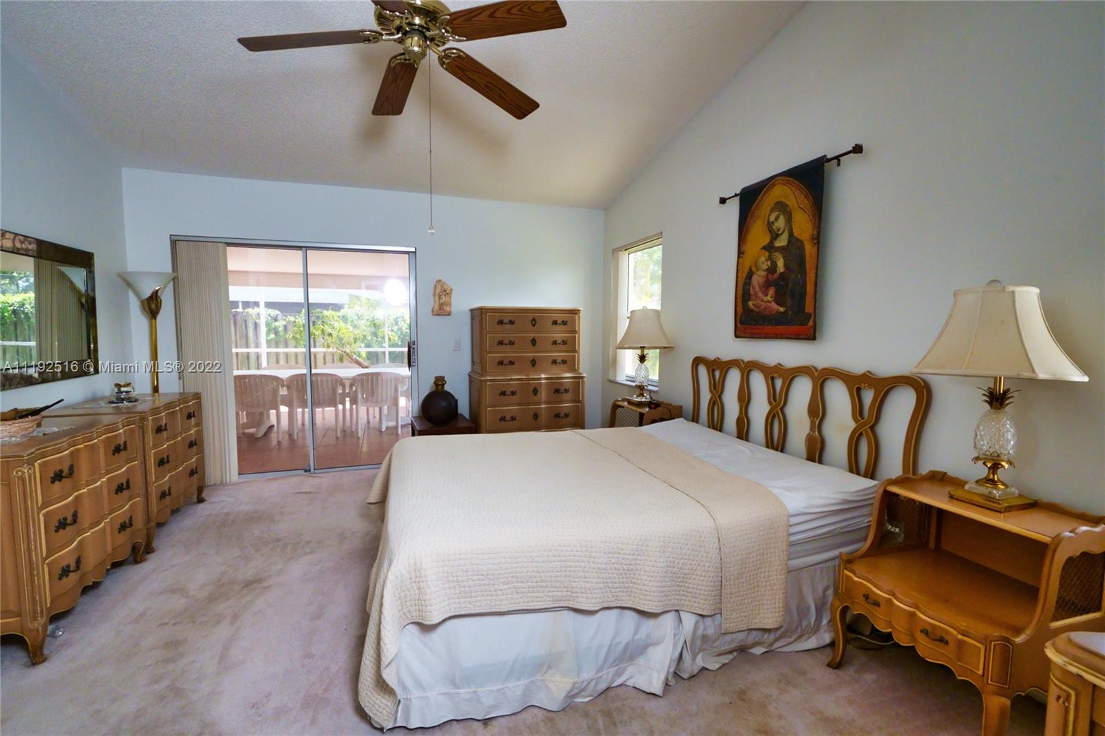 21291 Sawmill Court Boca Raton, FL 33498 - Photo 12 of 32 a bedroom with a bed and a flat tv screen on the dresser