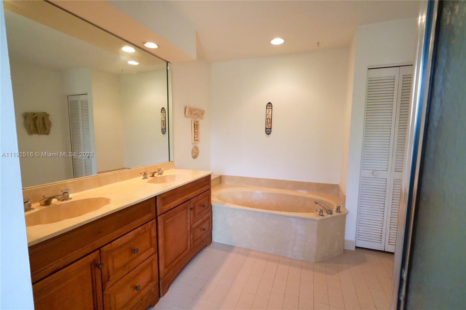 21291 Sawmill Court Boca Raton, FL 33498 - Photo 14 of 32 a spacious bathroom with a tub sink shower and mirror