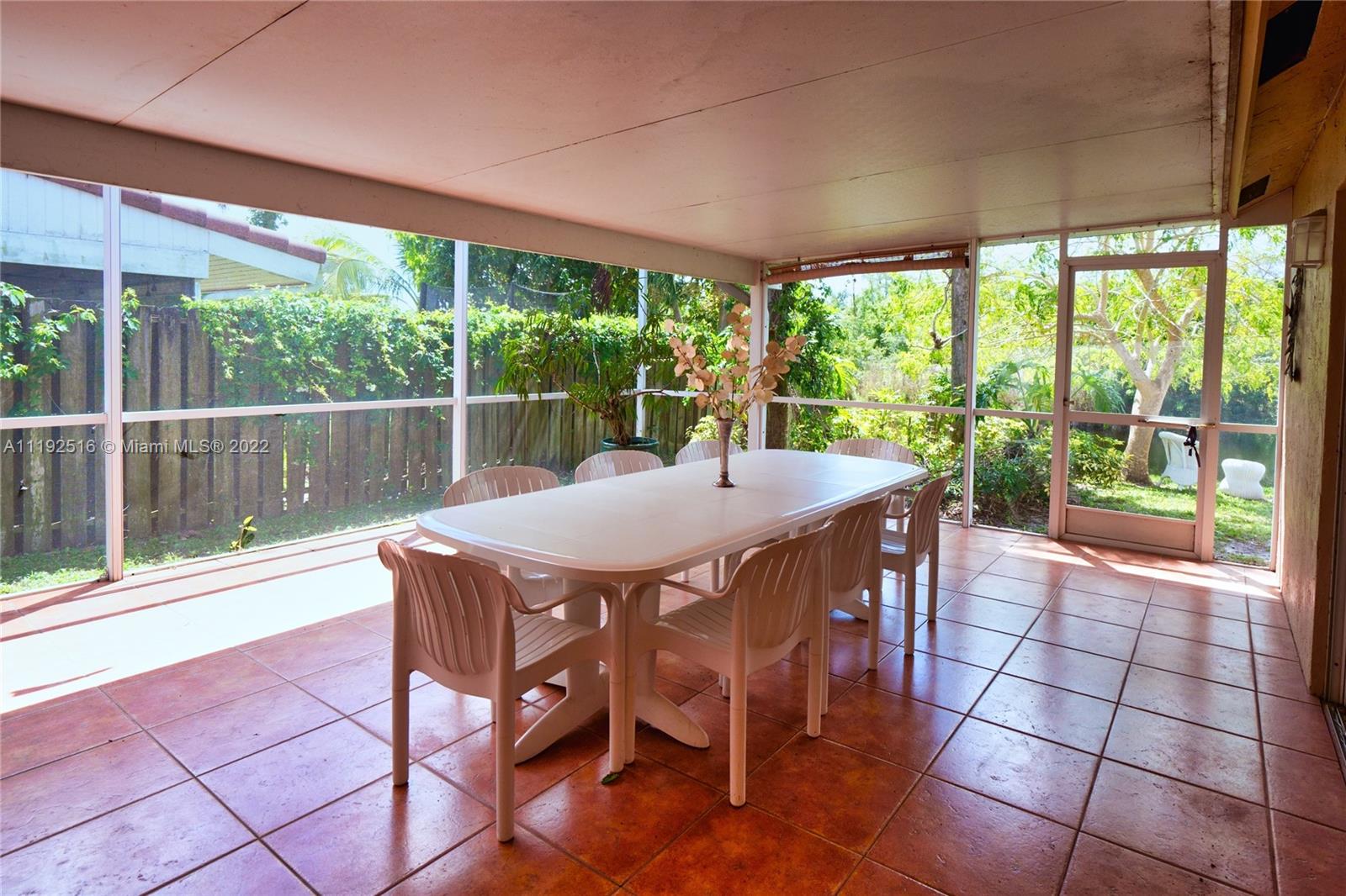21291 Sawmill Court Boca Raton, FL 33498 - Photo 29 of 32 a view of a patio with a table chairs and a backyard