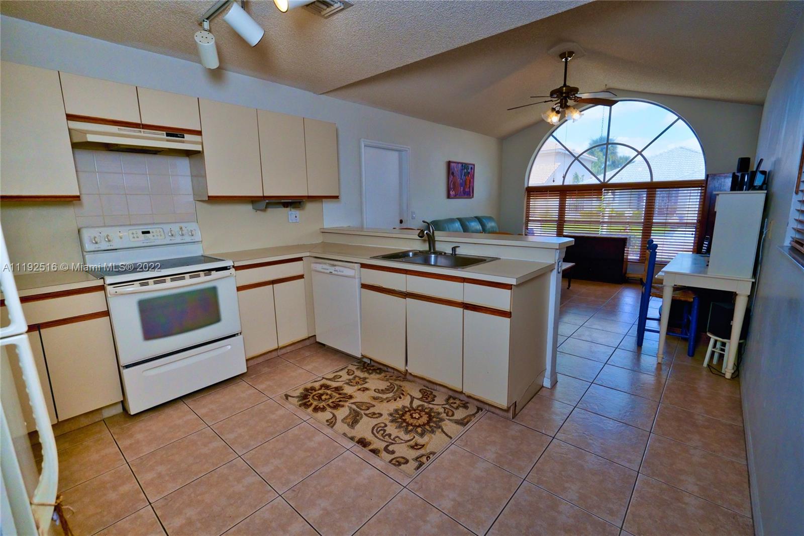 21291 Sawmill Court Boca Raton, FL 33498 - Photo 4 of 32 a kitchen with a stove sink and cabinets
