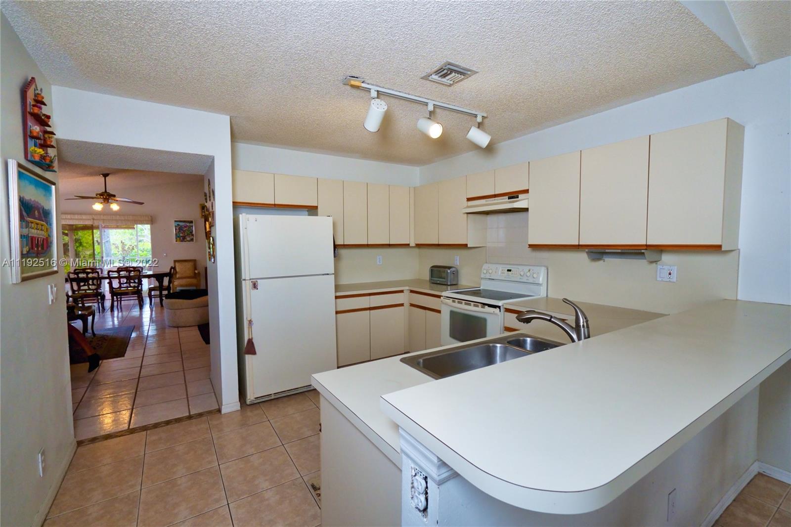 21291 Sawmill Court Boca Raton, FL 33498 - Photo 5 of 32 a kitchen that has a sink cabinets counter space and stainless steel appliances