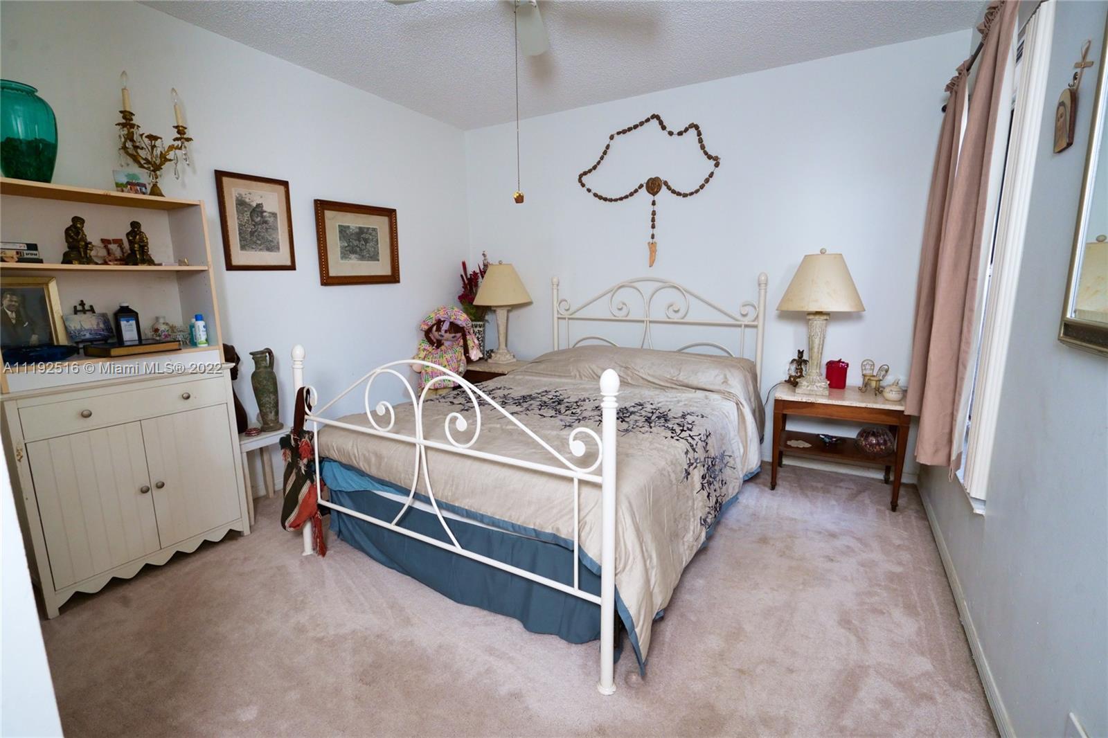 21291 Sawmill Court Boca Raton, FL 33498 - Photo 8 of 32 a bedroom with bed and a chandelier