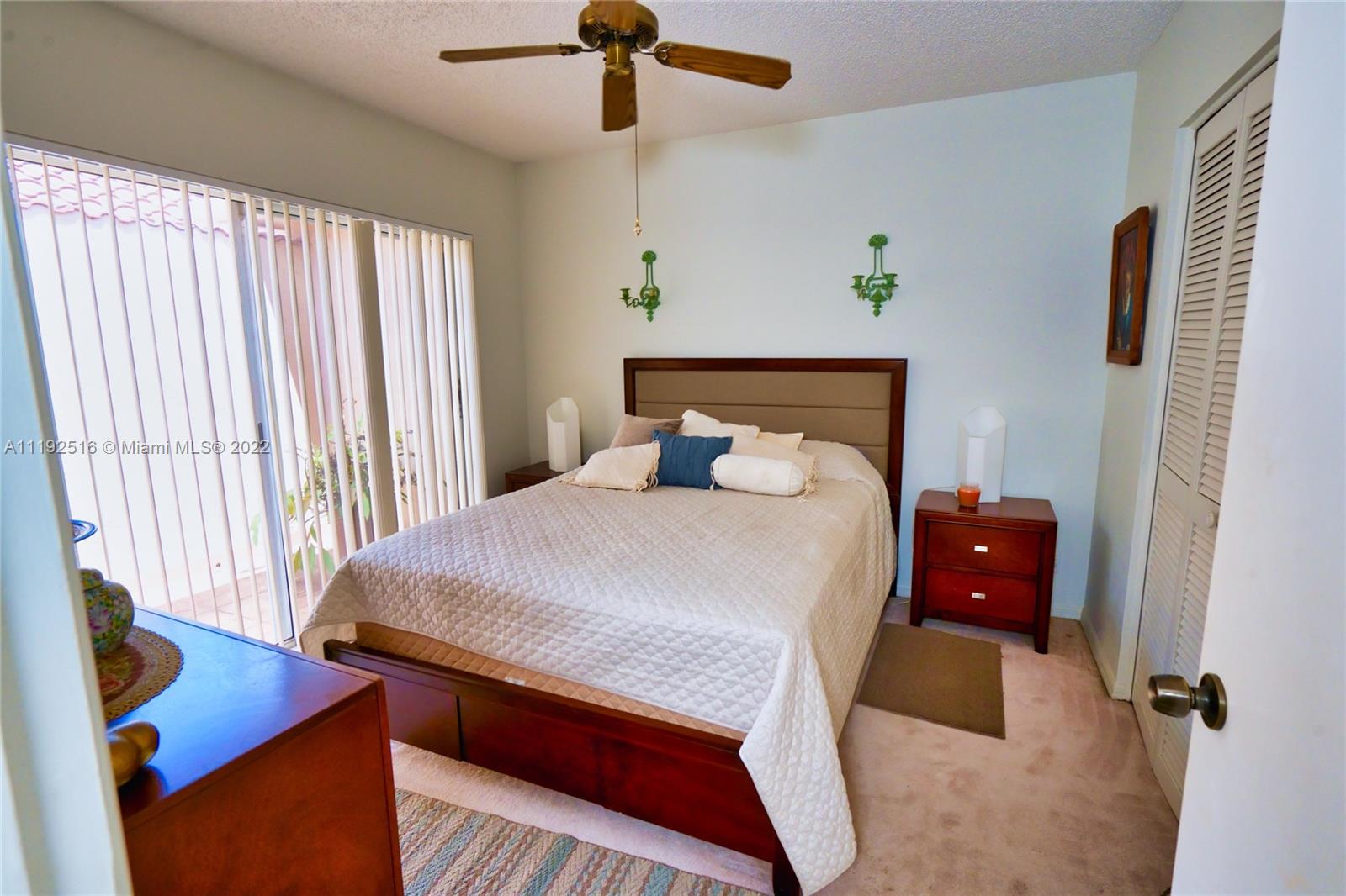 21291 Sawmill Court Boca Raton, FL 33498 - Photo 10 of 32 a bedroom with a bed and a window
