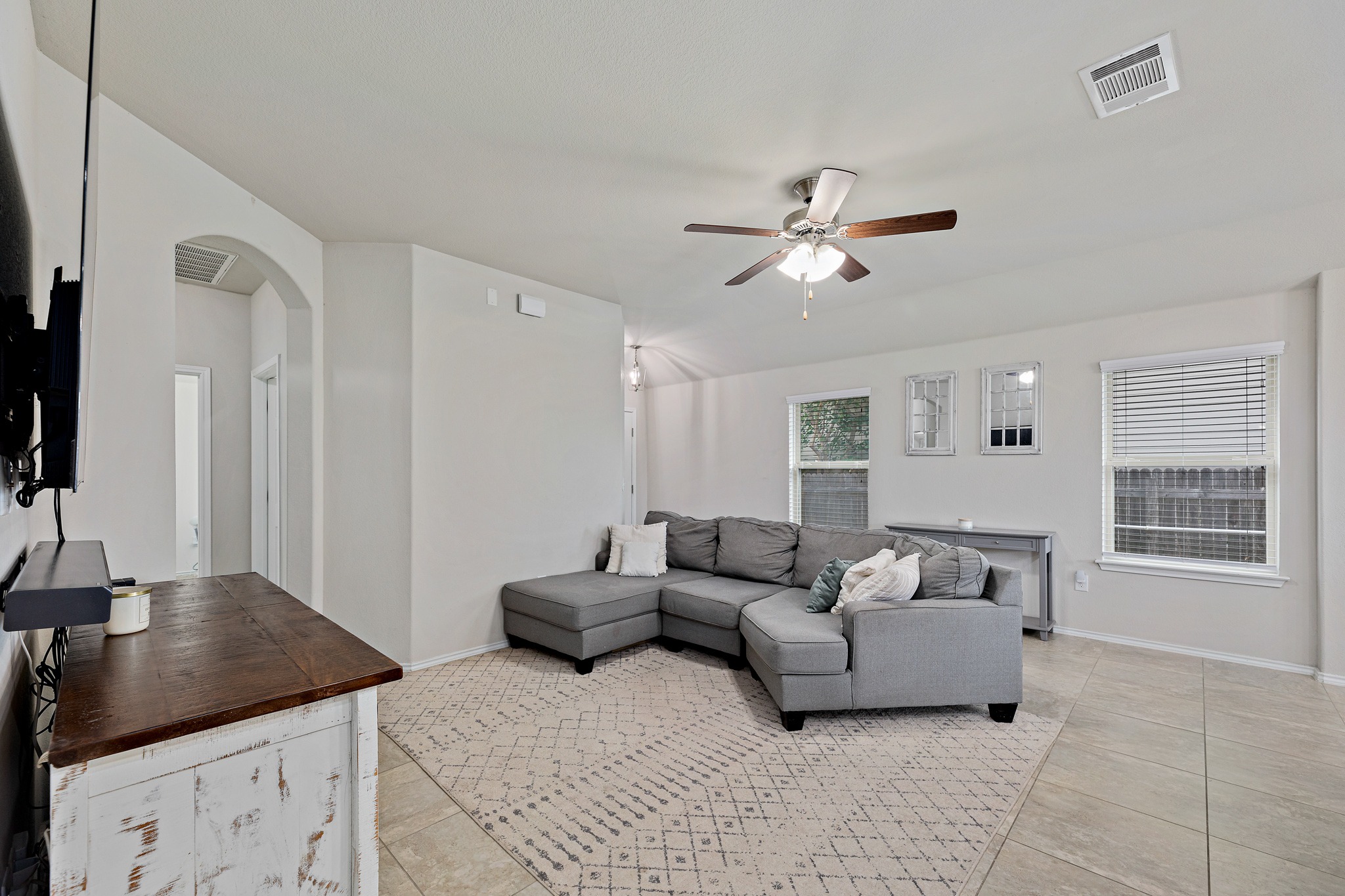 382 Limerick Road Buda, TX 78610 - Photo 4 of 20 A comfortable living area featuring ceramic tile flooring, a refreshing ceiling fan, and ample natural light.