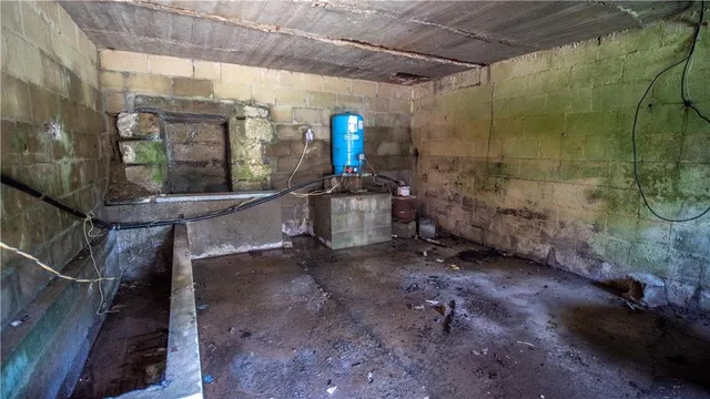 a view of a room with water heater and wooden walls