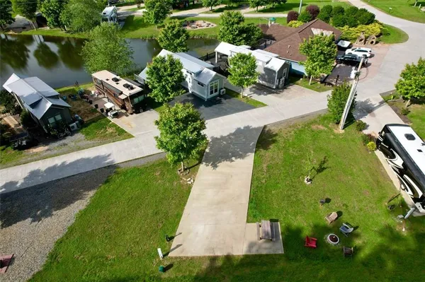 an aerial view of a house with a yard basket ball court and outdoor seating