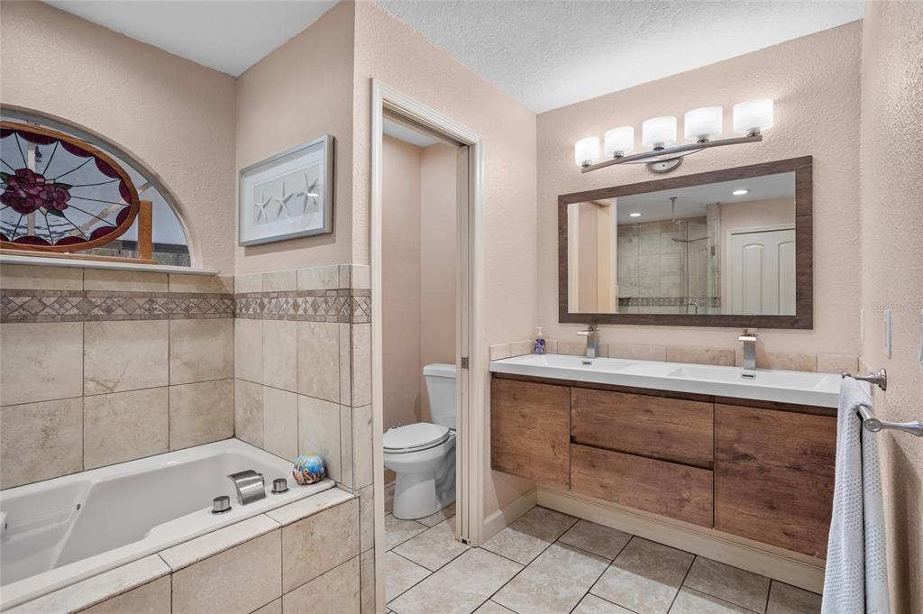 14612 Bray Road Orlando, FL 32832 - Photo 19 of 33 a bathroom with a tub sink and mirror