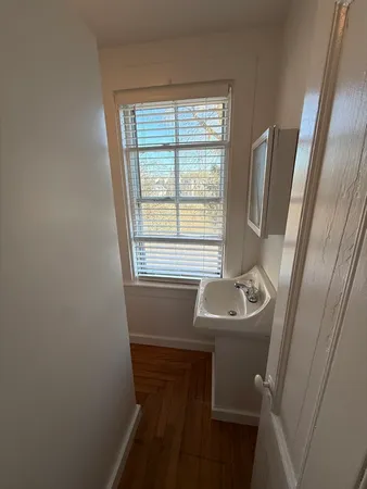 a bathroom with a sink a toilet and a window