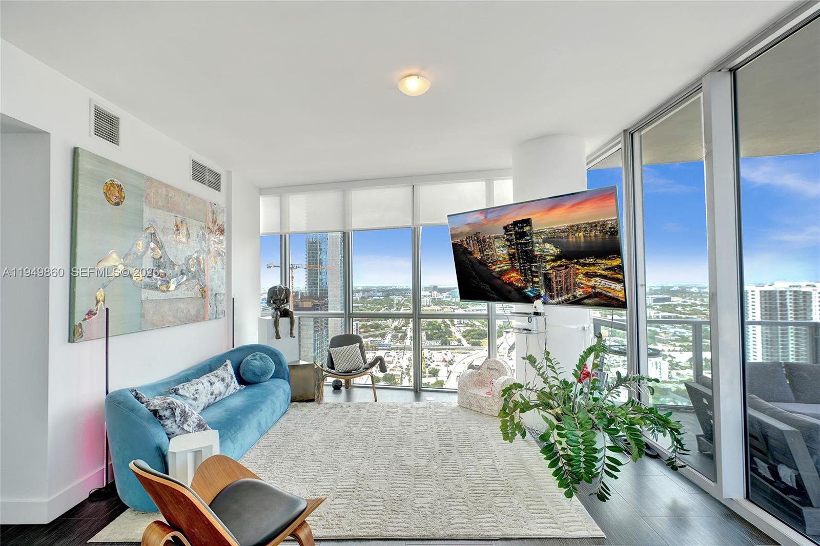 1100 Biscayne Boulevard, Unit 3708 Miami, FL 33132 - Photo 11 of 43 a living room with furniture and a flat screen tv