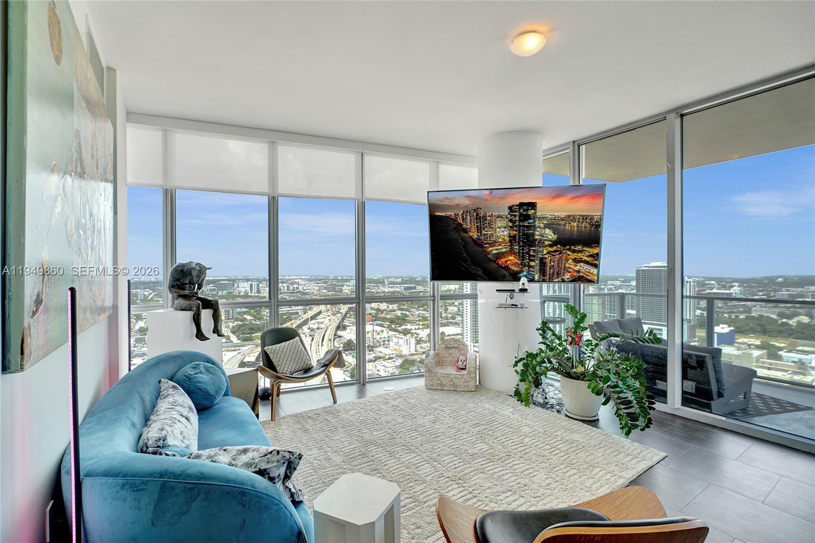 1100 Biscayne Boulevard, Unit 3708 Miami, FL 33132 - Photo 12 of 43 a living room with furniture kitchen view and a large window