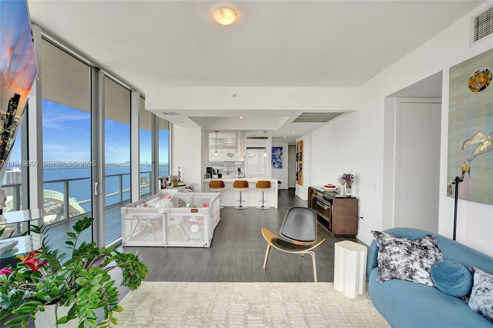 1100 Biscayne Boulevard, Unit 3708 Miami, FL 33132 - Photo 13 of 43 a living room with furniture potted plant and a chandelier