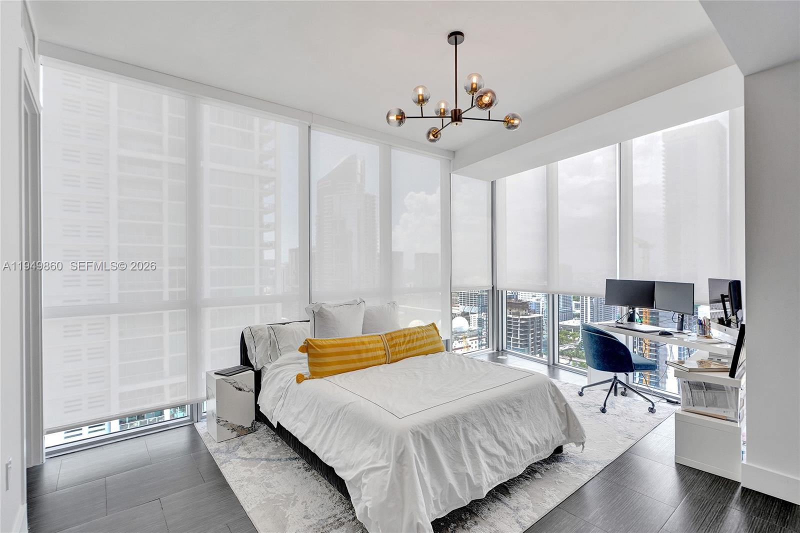 1100 Biscayne Boulevard, Unit 3708 Miami, FL 33132 - Photo 15 of 43 a bedroom with a bed a chandelier and large window