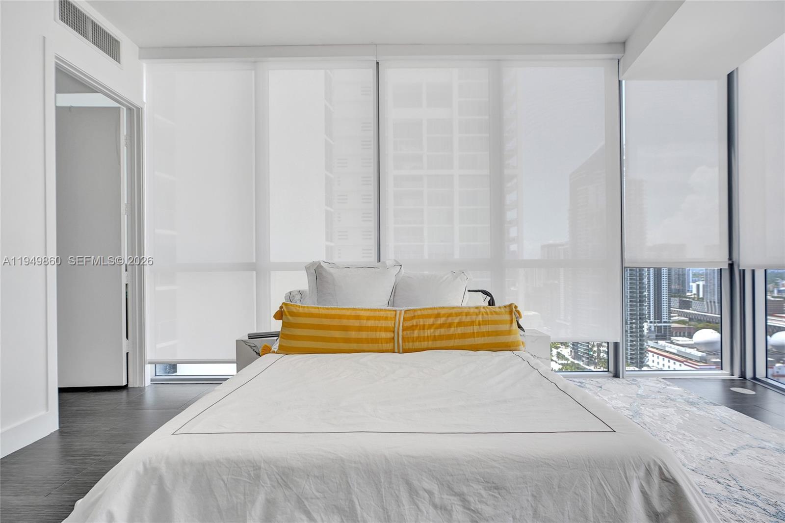 1100 Biscayne Boulevard, Unit 3708 Miami, FL 33132 - Photo 17 of 43 a bedroom with a large bed and a chandelier