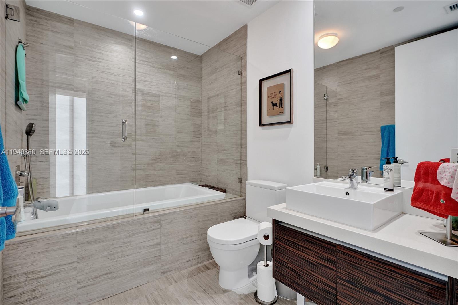 1100 Biscayne Boulevard, Unit 3708 Miami, FL 33132 - Photo 23 of 43 a bathroom with a sink a toilet and shower