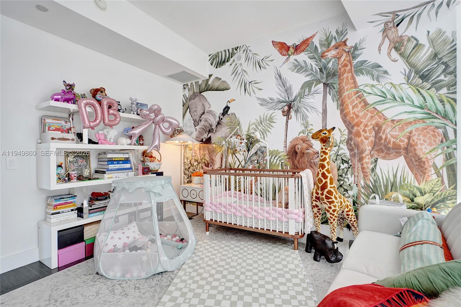 1100 Biscayne Boulevard, Unit 3708 Miami, FL 33132 - Photo 25 of 43 a bedroom with baby toys and a couch